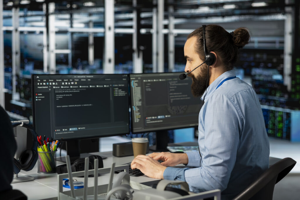 IT support engineer monitoring servers and providing business IT support services in a data center.